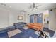 Comfortable living area with a large ceiling fan, sofa set, and vibrant blue accent wall at 1420 Logandale Dr, Logandale, NV 89021