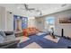 Spacious living room featuring ceiling fans, ample seating, and a workout area at 1420 Logandale Dr, Logandale, NV 89021