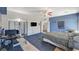 Comfortable bedroom with blue accent wall, plush carpet, and an ensuite bathroom for convenience at 1420 Logandale Dr, Logandale, NV 89021