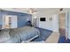 Spacious bedroom with blue accent wall, workstation, and an ensuite bathroom for convenience and privacy at 1420 Logandale Dr, Logandale, NV 89021