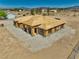 New construction home in a desert neighborhood with blue skies and mountain views, wooden framing at 1550 W Jornada St, Pahrump, NV 89048