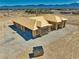 A high-angle view of the house in the desert with mountains in the background and blue skies at 1550 W Jornada St, Pahrump, NV 89048