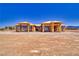 New construction home with a bright blue sky, wooden framing and black windows at 1550 W Jornada St, Pahrump, NV 89048