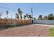 Gravel backyard with a wood fence and block wall, showcasing ample space for outdoor enjoyment at 1844 Yale St, North Las Vegas, NV 89030
