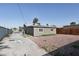 View of the backyard with privacy fencing, a graveled landscape, and a view of the back of the house at 1844 Yale St, North Las Vegas, NV 89030