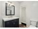 Bathroom features a modern vanity, toilet, mirror and a shower with a curtain at 1844 Yale St, North Las Vegas, NV 89030