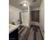 Bathroom with wood-look flooring, a shower, and ample natural light at 1844 Yale St, North Las Vegas, NV 89030