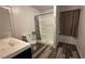 Neat bathroom features tile flooring and a shower with glass doors and a shower head at 1844 Yale St, North Las Vegas, NV 89030