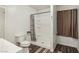 Bathroom featuring a toilet, shower stall, and vanity with a framed window and curtain at 1844 Yale St, North Las Vegas, NV 89030