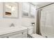 Bright bathroom features a modern vanity, toilet, and a shower with curtain at 1844 Yale St, North Las Vegas, NV 89030