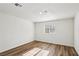 Bright, minimalist bedroom with wood-look floors and a window bringing in natural light at 1844 Yale St, North Las Vegas, NV 89030