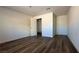 Bright bedroom has wood-look floors and white walls with an open door to bath at 1844 Yale St, North Las Vegas, NV 89030
