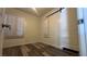 Bedroom with wood-look flooring, large window, and a modern sliding barn door at 1844 Yale St, North Las Vegas, NV 89030