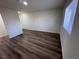 Bright bedroom with wood-look flooring and a window with blinds for privacy at 1844 Yale St, North Las Vegas, NV 89030