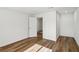 Minimalist bedroom featuring wood-look flooring, and neutral walls with an open doorway at 1844 Yale St, North Las Vegas, NV 89030