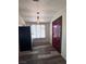 Entryway featuring dark-stained wood-look floors, a painted door, and modern lighting at 1844 Yale St, North Las Vegas, NV 89030