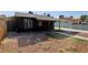 A front exterior shot of this house with a stone facade and covered porch, and a large driveway at 1844 Yale St, North Las Vegas, NV 89030