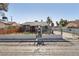 Front exterior view of home with a fenced yard, gated driveway, and a classic, well-maintained facade at 1844 Yale St, North Las Vegas, NV 89030