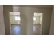 Hallway leading to bedrooms with windows and hardwood-style floors at 1844 Yale St, North Las Vegas, NV 89030