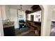 Compact kitchen with modern appliances and unique wood trim into adjoining room at 1844 Yale St, North Las Vegas, NV 89030
