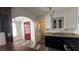 Kitchen with updated sink, stove, and access to laundry room and front entrance at 1844 Yale St, North Las Vegas, NV 89030