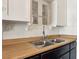Close up on kitchen sink and wood countertop with stainless faucet at 1844 Yale St, North Las Vegas, NV 89030