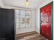 Eat in kitchen features stainless refrigerator and exterior red door with green trim at 1844 Yale St, North Las Vegas, NV 89030