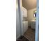 Compact laundry area features a stacked washer/dryer unit and a modern sink and vanity at 1844 Yale St, North Las Vegas, NV 89030