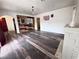Open living room with wood-look floors, a decorative fireplace, and a partial view of the kitchen at 1844 Yale St, North Las Vegas, NV 89030