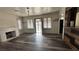 Spacious living room featuring a brick fireplace, wood-look flooring, and ample natural light at 1844 Yale St, North Las Vegas, NV 89030