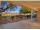 This covered patio overlooks lush landscaping and a golf course at 2110 Fort Sanders St, Henderson, NV 89052