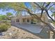 Backyard patio area features a covered porch, desert landscaping, and a cozy retreat at 2110 Fort Sanders St, Henderson, NV 89052