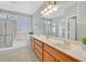 Bathroom with dual sinks, bathtub, and walk-in shower at 2110 Fort Sanders St, Henderson, NV 89052
