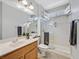 Bright bathroom with glass enclosed shower, vanity, framed mirror, and tiled floor at 2110 Fort Sanders St, Henderson, NV 89052