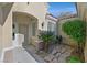 Inviting entryway with stone-paved pathway, desert landscaping and security gate at 2110 Fort Sanders St, Henderson, NV 89052