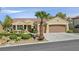 Charming single-story home featuring a well-manicured yard, desert landscaping, and a two-car garage at 2110 Fort Sanders St, Henderson, NV 89052