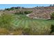 Beautiful view of the golf course with manicured green fairways and a luxury home in the background at 2110 Fort Sanders St, Henderson, NV 89052