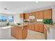 Bright kitchen featuring an island, wood cabinets, and modern appliances at 2110 Fort Sanders St, Henderson, NV 89052