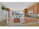 Well-lit kitchen with central island, wood cabinets and granite countertops at 2110 Fort Sanders St, Henderson, NV 89052