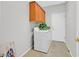 Functional laundry room featuring a washer, dryer and storage cabinets at 2110 Fort Sanders St, Henderson, NV 89052