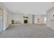 Spacious living room features fireplace, carpet flooring and sliding glass door to the backyard at 2110 Fort Sanders St, Henderson, NV 89052
