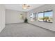 Living room features large windows overlooking the backyard and carpet flooring at 2110 Fort Sanders St, Henderson, NV 89052