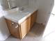 Bathroom vanity with wood cabinet and tile countertop at 2110 Los Feliz St # 1083, Las Vegas, NV 89156