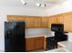 Cozy kitchen with wooden cabinets, modern appliances, and tile countertops at 2110 Los Feliz St # 1083, Las Vegas, NV 89156