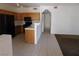 A kitchen is featured with wood cabinets and black appliances including a refrigerator, stove and microwave at 2110 Los Feliz St # 1083, Las Vegas, NV 89156