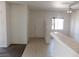 A bright living room with a white door, neutral paint and a bar into the kitchen with tile floors at 2110 Los Feliz St # 1083, Las Vegas, NV 89156