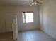 A living space with neutral paint, tile floors, a bar into the kitchen and bright natural light at 2110 Los Feliz St # 1083, Las Vegas, NV 89156
