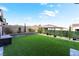 Private backyard featuring artificial grass, landscaped walls, and a storage box at 212 Harris Peak St, Las Vegas, NV 89138
