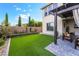 Backyard featuring manicured lawn and patio with seating area under pergola at 212 Harris Peak St, Las Vegas, NV 89138