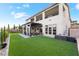 Expansive backyard with artificial grass, covered patio, and outdoor seating at 212 Harris Peak St, Las Vegas, NV 89138